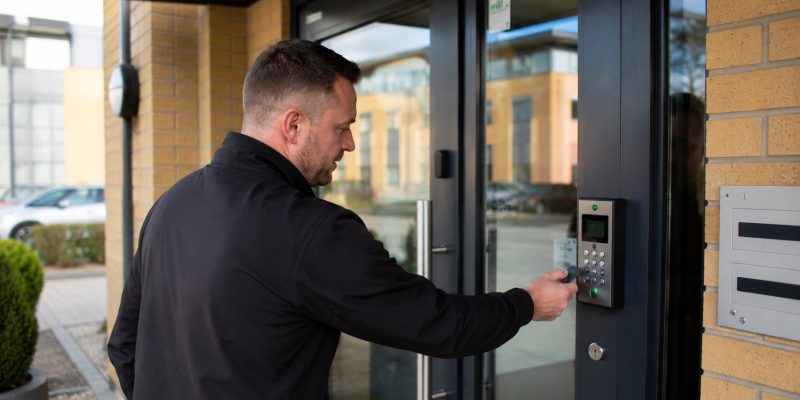 Man interacting with modern door access system
