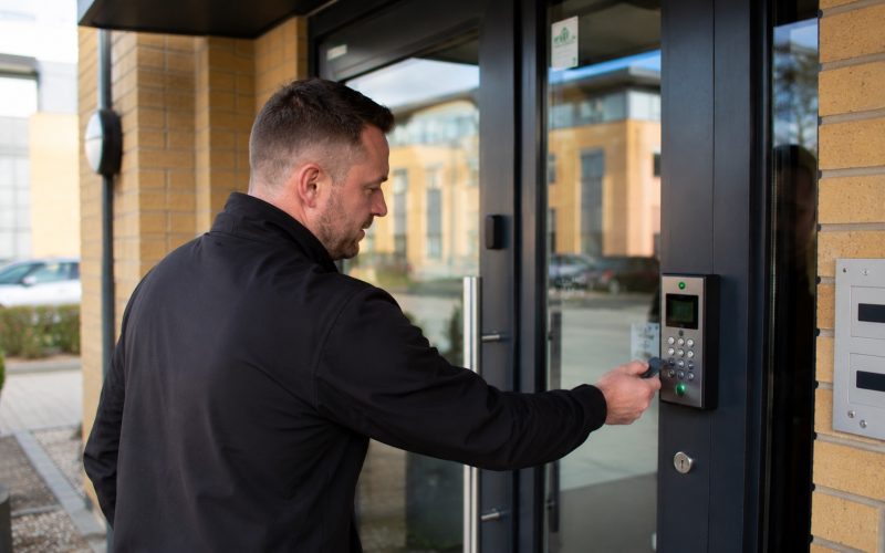 Man interacting with modern door access system